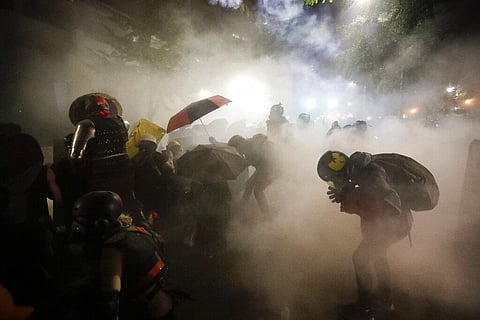 Federal officers launch tear gas at a group of demonstrators during a Black Lives Matter protest in Portland. (Photo| AP)