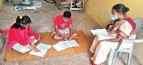 Dr Anupama Mishra teaches students at their homes in Dhenkanal town on Monday. (Photo| EPS)