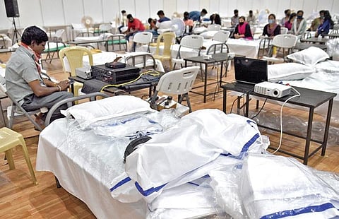 A staffer checks the infrastructure at the country’s biggest Covid Care Centre at the BIEC, which opened in Bengaluru on Monday | NAGARAJA GADEKAL