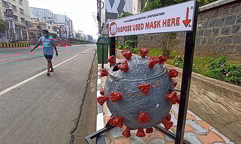 A different bin arranged for disposing used masks by VMC at MG road in Vijayawada. (Photo | P Ravindra Babu, EPS)
