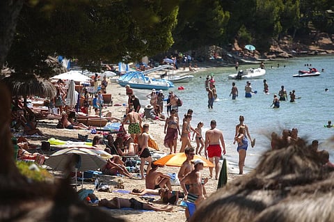 Sunbathers enjoy the beach in Pollença, in the Balearic Island of Mallorca, Spain, Tuesday, July 28, 2020. (Photo | AP)