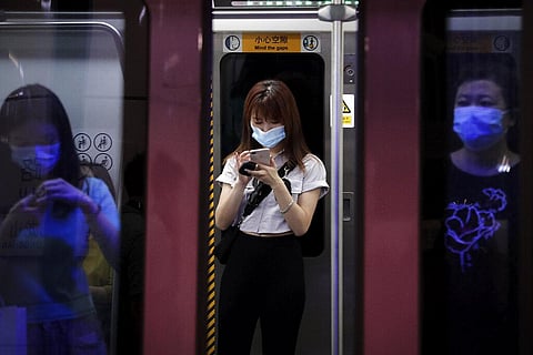 Commuters wearing face masks to protect against the new coronavirus ride in a subway train in Beijing. (Photo | AP)
