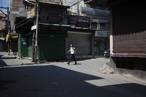 A Kashmiri man walks at a closed market during a lockdown in Srinagar, Thursday, July 23, 2020. (Photo | AP)