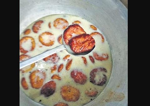 Rasabali is a fried flattened brown cheese cake soaked in thickened and sweetened milk.