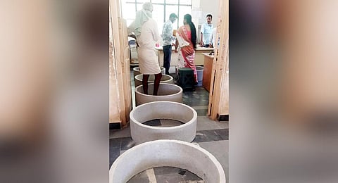 Cement rings on the floor to ensure social distancing at sub-registrar’s office in Koppal. (Photo | Express)
