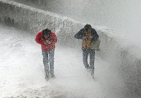 People escape a wave from the Atlantic Ocean. (Photo | AP)