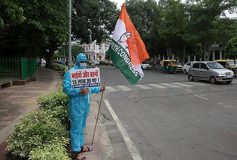 Youth Congress worker wearing PPE kits stage a protest over COVID-19 situation as coronavirus cases across the nation has crossed 15 lakh. (Photo | Shekhar Yadav, EPS)
