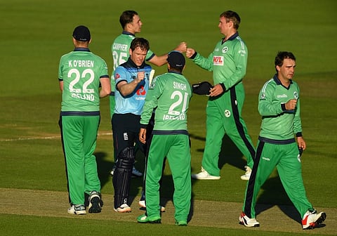 England's Eoin Morgan (2nd L) touches hands with Ireland's Simi Singh (C) at the end of the match during the first One Day International cricket match between England and Ireland. (Photo | AFP)