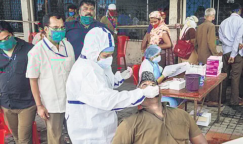 A medic takes samples from a man at a free rapid antigen testing camp in Thane | PTI