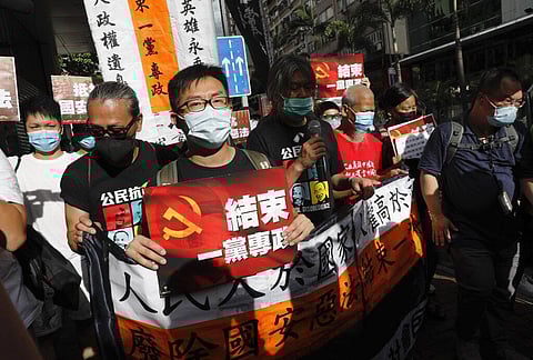 Pro-democracy protesters shout slogans 'Stop One Party Rolling' as they march toward the flag raising ceremony in Hong Kong on July 1, 2020. (Photo | AP)