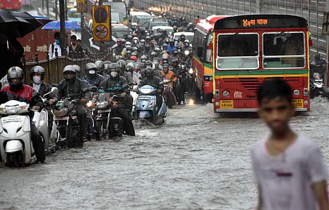 Vehicles move slowly on a waterlogged street during rain at King's circle in Mumbai Friday July 3 2020. (Photo | PTI)