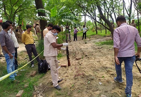 Kanpur Police and forensic team members investigate the encounter site where 8 police personnel lost their lives after being fired upon by criminals in Kanpur Friday July 3 2020.  (Photo | PTI)