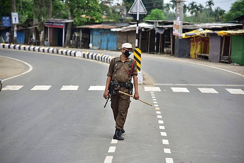 A security personnel stands guard during the strict lockdown imposed by the Assam. (Photo| PTI)
