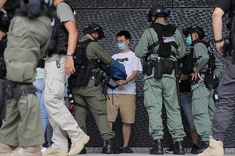 Riot police checks a man near the U.S. Consulate in Hong Kong, Saturday, July 4, 2020 to mark the American Independence Day or 'the Fourth of July.' (Photo | AP)