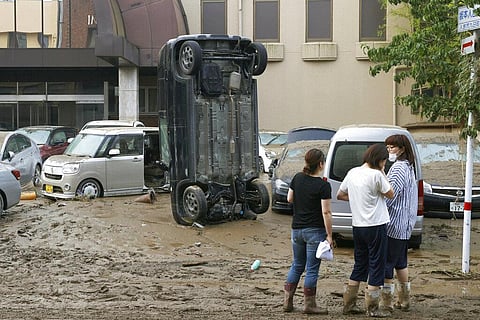 A car stands vertically on a muddy road after being washed away by flood, in Hitoyoshi, Kumamoto prefecture, southwestern Japan, Sunday, July 5, 2020. (Photo | AP)
