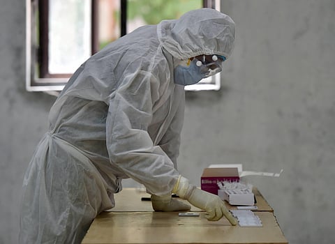 A medic during collection of samples for COVID-19 diagnosis via rapid-antigen testing.(Photo | PTI)