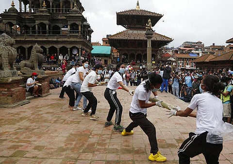 Nepalese youth perform a play as part of a protest demanding better COVID-19 management at Patan Durbar Square near Kathmandu, Nepal, Tuesday, June 30, 2020. (Photo | AP)
