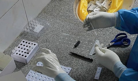 A health official labels rapid test kits at a temporary COVID-19 free testing facility. (Photo | Shekhar Yadav/EPS)