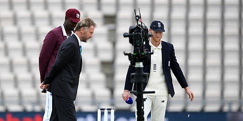 England captain Ben Stokes, right, and West Indies' captain Jason Holder, left, watch the coin before Stoke won the toss on the first day of the 1st cricket Test match between England and West Indies, at the Ageas Bowl in Southampton. (Photo | AP)