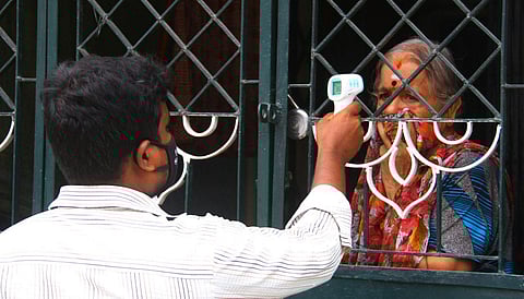 Corporation worker carrying out door-to-door screening in Madurai. (Photo | K K Sundar, EPS)