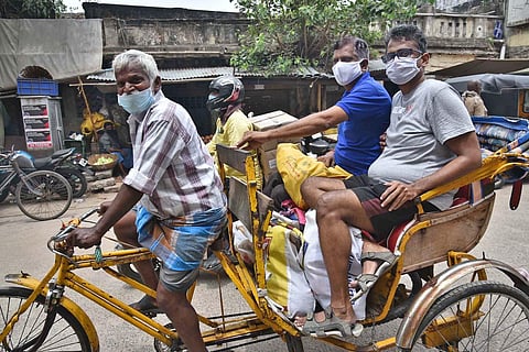 Two passengers wearing face masks seen on a cycle rickshaw in Chennai on Monday | P Jawahar