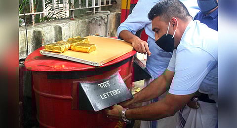 Youth League activists symbolically sending ‘gold bars’ to Chief Minister’s office at the head post office in Kozhikode on Tuesday as part of their protest | T P Sooraj