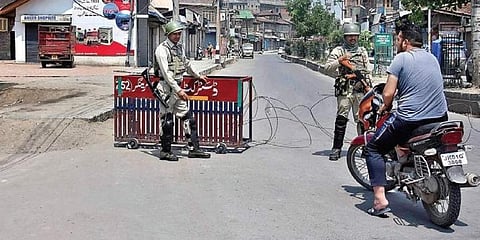 Security forces stop people during restrictions imposed in Srinagar. | Zahoor Punjabi