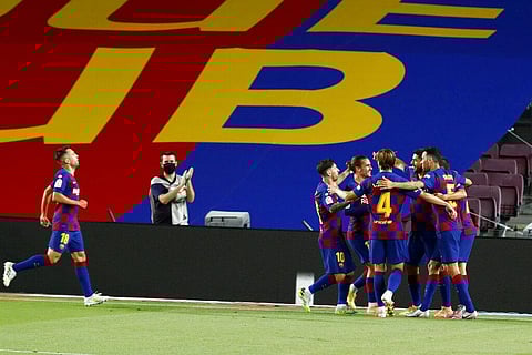 Barcelona's Luis Suarez celebrates with teammates scoring the opening goal during the Spanish La Liga soccer match between FC Barcelona and RCD Espanyol at the Camp Nou stadium in Barcelona. (Photo | AP)