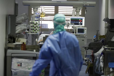 In this Monday, March 16, 2020 file photo, a doctor watches a coronavirus patient under treatment in the intensive care unit of the Brescia hospital, Italy.  (Photo | AP)