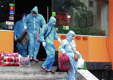 People walk toward an ambulance to be driven to a hospital for quarantine relating to a suspected COVID-19 case in Hanoi, Vietnam, Wednesday, July 29, 2020.  (Photo | AP)