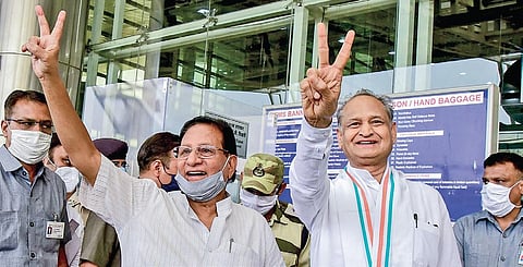 Rajasthan CM Ashok Gehlot and senior Congress leader Shanti Dhariwal flash victory sign at Jaipur airport. (Photo| PTI)