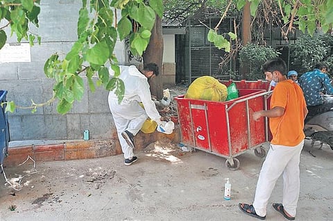 A health worker handles discarded PPE kits at LNJP Hospital. (Photo | Shekhar Yadav, EPS)
