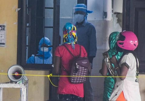 People waiting outside of a Covid-19 testing center at Capital Hospital in Bhubaneswar. (Photo | Biswanath Swain/EPS)