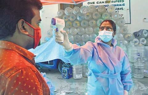 Thermal scan being done at a fever camp by doctors and corporation officials at  T Nagar in Chennai (Photo | Ashwin Prasath, EPS)