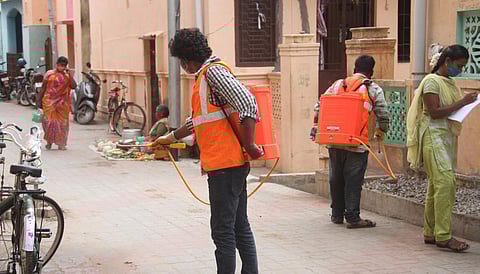 Corporation workers spraying disinfectant at Goripalayam in Madurai (Photo | EPS/KK Sundar)