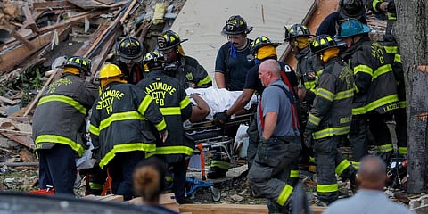 Baltimore City Fire Department carries a person out from the debris after an explosion in Baltimore on Monday. (Photo | AP)