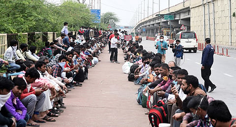(Image used for representation only) Migrant workers on their way to Uttar Pradesh sit in rows to avail food served by social workers in Ghaziabad on Friday. (Photo | Parveen Negi/EPS)