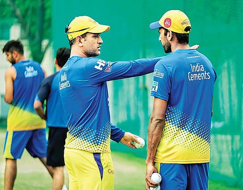 CSK skipper MS Dhoni (left) with bowling coach Lakshmipathy Balaji on Saturday