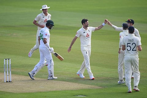 England's James Anderson celebrates taking the wicket of Pakistan's Shan Masood. (Photo | AFP)