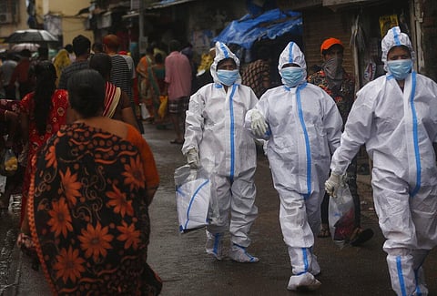 Health workers return after screening people for COVID-19 symptoms in Dharavi, one of Asia's biggest slums, in Mumbai, India, Tuesday, Aug. 11, 2020. (Photo | AP)