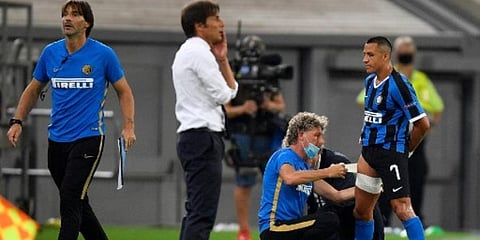 Inter Milan's Alexis Sanchez receives medical attention during the UEFA Europa League quarter-final football match against Leverkusen. (Photo | AFP)
