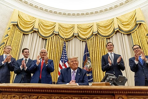 President Donald Trump, accompanied by officials in the Oval Office at the White House. (Photo | AP)