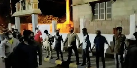 A video of the youth quickly forming the human chain to protect the Hanuman temple on Shampura Main Road has gone viral. (Photo | YouTube Screengrab)