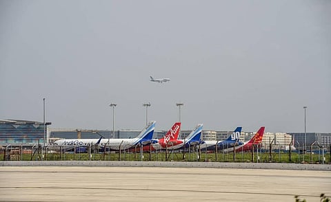 A plane lands at IGI Airport as others stand parked during Unlock 2 in New Delhi. (Photo | PTI)