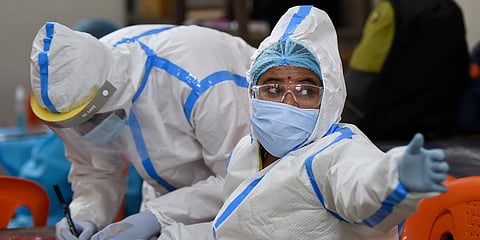 Health workers collect samples via Rapid Antigen kit for COVID-19 test. (Photo | PTI)