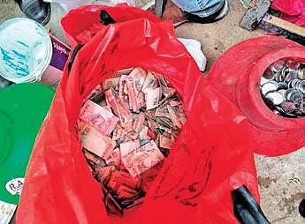 The currency notes and coins found  at Prabhavathi’s home | Express