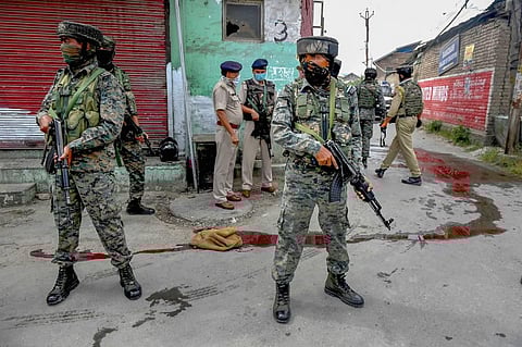 Security personnel stand guard at the spot after a militant attack at Nowgam bypass in Srinagar Friday Aug 14 2020. (Photo | PTI)
