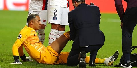 PSG goalkeeper Keylor Navas receives first aid after an injuring during the Champions League quarter-final against Atalanta. (Photo | AP)
