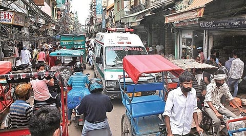 An ambulance carrying Covid patient stuck in traffic at Lal Kuan in old Delhi on Friday. (Photo | EPS/Shekhar Yadav)