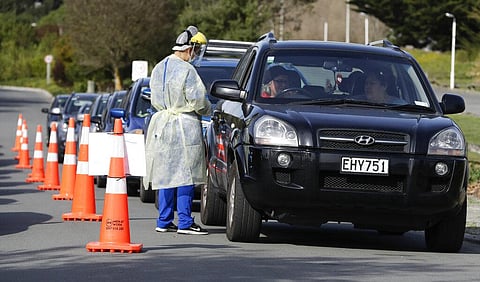 Medical staff prepare take a COVID-19 test from a visitor to a drive through community based assessment centre in Christchurch, New Zealand, Thursday, Aug. 13, 2020.  (Photo | AP)